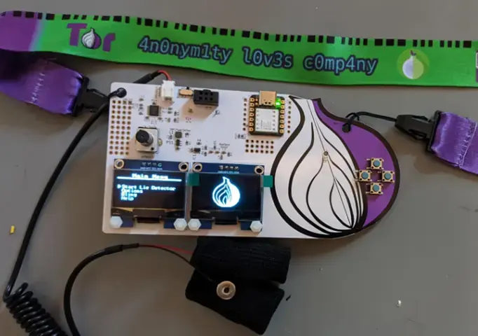 DEF CON TOR 29 badge with an onion logo, two small screens, and a lanyard
