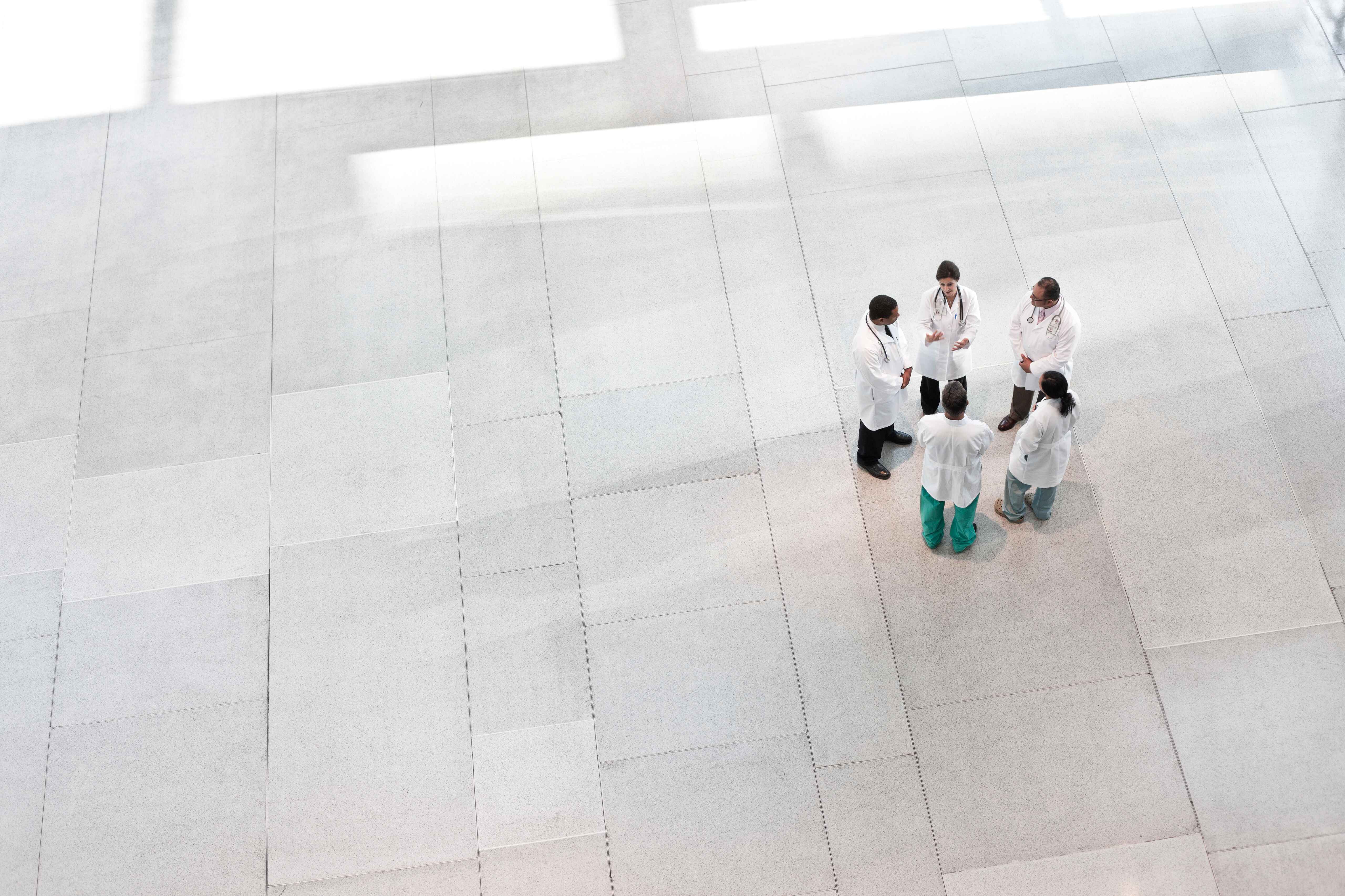 Mixed race group of doctors meeting in lobby of la 2022 03 04 02 13 13 utc